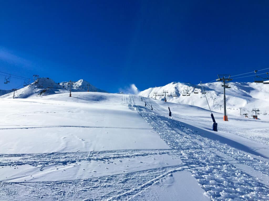 Ski slopes with snowmobile tracks